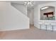 Bright living room featuring plush carpeting, staircase to the second floor, and open access to the kitchen at 2173 Tuscany Trce # 8, Palm Harbor, FL 34683
