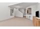 Bright living room featuring plush carpeting, modern light fixture, and open access to the kitchen at 2173 Tuscany Trce # 8, Palm Harbor, FL 34683