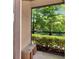 Peaceful screened patio featuring a view of lush greenery and a serene lake at 2173 Tuscany Trce # 8, Palm Harbor, FL 34683