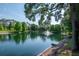 Scenic view of a tranquil pond with a fountain, framed by lush greenery at 2173 Tuscany Trce # 8, Palm Harbor, FL 34683