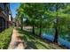 Picturesque pond view with lush green trees lining a walking path by the water at 2173 Tuscany Trce # 8, Palm Harbor, FL 34683