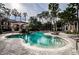Enjoy this community pool surrounded by palm trees, lounge chairs, and lush landscaping at 2173 Tuscany Trce # 8, Palm Harbor, FL 34683