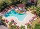 Overhead view of the community pool, featuring a hot tub, waterfall, and plenty of lounge chairs at 2173 Tuscany Trce # 8, Palm Harbor, FL 34683