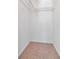 An empty walk-in closet with shelving and carpeted floor at 2173 Tuscany Trce # 8, Palm Harbor, FL 34683