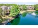 Scenic waterfront property featuring lush landscaping, a tranquil pond with a fountain, and elegant residential buildings at 2173 Tuscany Trce # 8, Palm Harbor, FL 34683