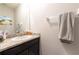Granite counter tops over dark cabinets, mirror, and towel rack in bathroom at 2247 Midnight Pearl Dr, Sarasota, FL 34240