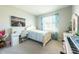 Cozy bedroom with plush carpet, complemented by a bright window with blue curtains at 2247 Midnight Pearl Dr, Sarasota, FL 34240