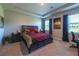 Relaxing primary bedroom showcasing a tray ceiling, ample natural light, and a calming color palette at 2247 Midnight Pearl Dr, Sarasota, FL 34240