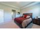 This bedroom features a tray ceiling, neutral walls, and carpet flooring at 2247 Midnight Pearl Dr, Sarasota, FL 34240