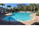 Inviting community pool surrounded by comfortable lounge chairs, providing a perfect spot for relaxation and recreation at 2247 Midnight Pearl Dr, Sarasota, FL 34240