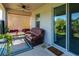 Relaxing covered patio with comfortable seating, decorative lattice, and a sliding glass door leading to the indoors at 2247 Midnight Pearl Dr, Sarasota, FL 34240