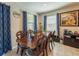 This dining room offers a wooden table, detailed chairs, tile flooring and natural lighting at 2247 Midnight Pearl Dr, Sarasota, FL 34240