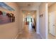 Inviting hallway with tile flooring, neutral walls, and glimpses of the spacious living area at 2247 Midnight Pearl Dr, Sarasota, FL 34240