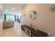Bright hallway leading to an open-concept living area with tile floors and stylish decor at 2247 Midnight Pearl Dr, Sarasota, FL 34240