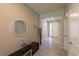 View of a spacious home hallway featuring decorative mirror, decorations, and tiled floors at 2247 Midnight Pearl Dr, Sarasota, FL 34240