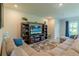 Relax in the living room featuring comfortable sectional seating and sliding glass door access to outdoors at 2247 Midnight Pearl Dr, Sarasota, FL 34240