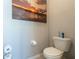 Bathroom featuring toilet with sunset painting displayed on the wall at 2247 Midnight Pearl Dr, Sarasota, FL 34240
