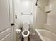 Bright bathroom featuring a toilet, shower-tub combo with tiled walls, and modern fixtures at 2325 Via Bella Blvd, Land O Lakes, FL 34639