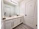 Bathroom featuring a double sink vanity with modern fixtures, a large mirror, and ample storage space at 2325 Via Bella Blvd, Land O Lakes, FL 34639