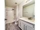 Clean bathroom features a white vanity with granite countertop and a stand-up shower at 2325 Via Bella Blvd, Land O Lakes, FL 34639