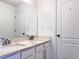 Bathroom featuring a double vanity with granite countertops and white cabinets at 2325 Via Bella Blvd, Land O Lakes, FL 34639