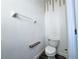 Half-bath featuring a toilet, small shelf, and towel rack at 2325 Via Bella Blvd, Land O Lakes, FL 34639