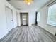 Bright bedroom with wood-look floors, closet, closet organizer, and windows at 2325 Via Bella Blvd, Land O Lakes, FL 34639