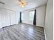 Bright bedroom with wood-look floors, ceiling fan, windows, and closet at 2325 Via Bella Blvd, Land O Lakes, FL 34639