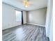 Spacious bedroom with wood-look floors, a large window, and neutral walls at 2325 Via Bella Blvd, Land O Lakes, FL 34639