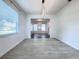 Bright dining room featuring hardwood floors, a modern chandelier and window with blinds at 2325 Via Bella Blvd, Land O Lakes, FL 34639