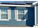 Close-up of a home exterior showing the siding, windows, and solar panels at 2325 Via Bella Blvd, Land O Lakes, FL 34639