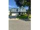 Charming two-story blue home with a well-maintained front yard and a two car garage at 2325 Via Bella Blvd, Land O Lakes, FL 34639