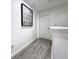 Hallway with gray flooring, white walls and clock decor at 2325 Via Bella Blvd, Land O Lakes, FL 34639