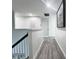 Second floor hallway with light gray vinyl plank flooring and white walls at 2325 Via Bella Blvd, Land O Lakes, FL 34639