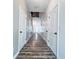 Hallway with several white doors, wood-look floors and artwork on wall at 2325 Via Bella Blvd, Land O Lakes, FL 34639