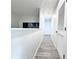 Hallway featuring grey wood-style laminate flooring leading to rooms in the home at 2325 Via Bella Blvd, Land O Lakes, FL 34639
