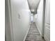 Hallway with wood-look floors, white walls, and doors at 2325 Via Bella Blvd, Land O Lakes, FL 34639