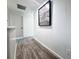 Upstairs hallway with light gray vinyl flooring and a decorative clock on the wall at 2325 Via Bella Blvd, Land O Lakes, FL 34639