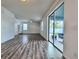 Bright living room with sliding glass doors and wood-style flooring at 2325 Via Bella Blvd, Land O Lakes, FL 34639