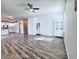 Open concept living space with hardwood floors, modern lighting, and white walls at 2325 Via Bella Blvd, Land O Lakes, FL 34639