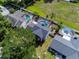 Aerial perspective of a home surrounded by verdant lawns, enclosed pools, and a secure white fence at 2619 Green Valley St, Valrico, FL 33596