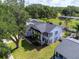 Elevated view of a residence showcasing a well-manicured lawn, mature trees, and classic architectural details at 2619 Green Valley St, Valrico, FL 33596