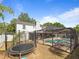 Backyard features a trampoline and screened-in pool with brick paver deck at 2619 Green Valley St, Valrico, FL 33596