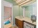 Bathroom featuring a vanity with sink, mirror and an adjacent room with toilet at 2619 Green Valley St, Valrico, FL 33596