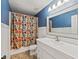 Bathroom features white vanity with sink and colorful shower curtain at 2619 Green Valley St, Valrico, FL 33596