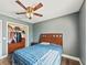 Bedroom features gray walls, wood floors, closet, ceiling fan, window, and bed at 2619 Green Valley St, Valrico, FL 33596