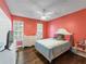 Bedroom featuring bright walls, hardwood floors, a dresser and two windows at 2619 Green Valley St, Valrico, FL 33596