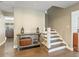 Inviting entryway featuring hardwood floors, a console table with decor, and a staircase leading to the upper level at 2619 Green Valley St, Valrico, FL 33596