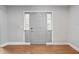 A gray entryway with a six panel door, sidelights and hardwood floors at 2619 Green Valley St, Valrico, FL 33596