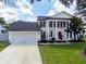 Charming two-story home featuring a two-car garage, well-manicured lawn, and elegant architectural details at 2619 Green Valley St, Valrico, FL 33596